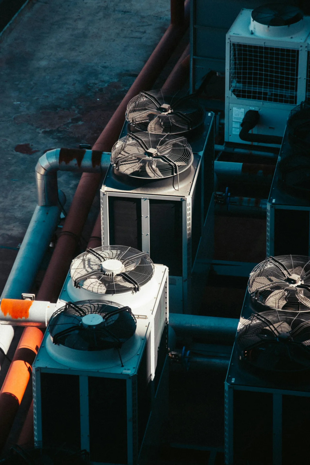 Commercial rooftop HVAC condenser units on a multi-unit building